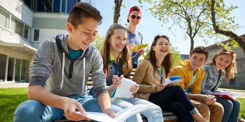 group of students with notebooks at school yard Schulen anderer Träger